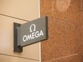 Omega watches brand logo in close-up at retail store.